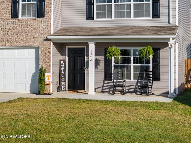 entrance to property with a lawn and a garage