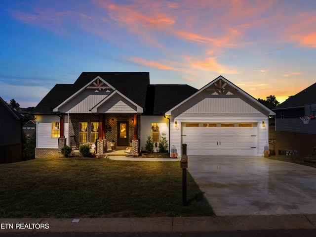 craftsman-style home featuring a lawn and a garage