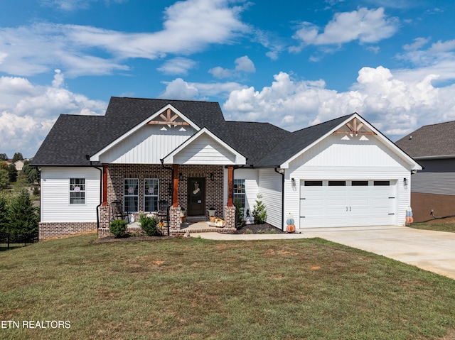 craftsman house with a garage and a front lawn