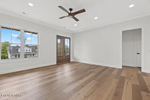 unfurnished room with ceiling fan, light hardwood / wood-style floors, and crown molding