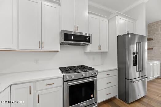 kitchen featuring hardwood / wood-style floors, white cabinets, and premium appliances