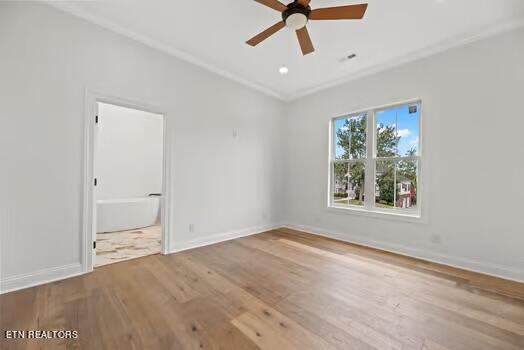 unfurnished bedroom with hardwood / wood-style floors, connected bathroom, and ceiling fan