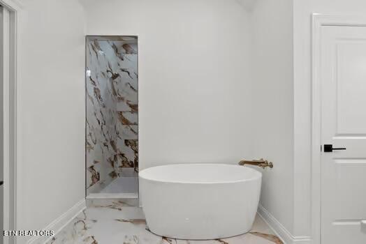 bathroom with a tub to relax in