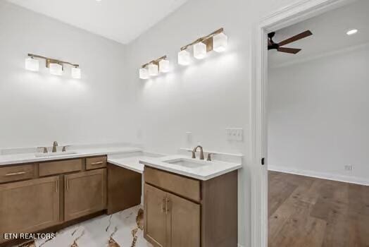 bathroom featuring ceiling fan, vanity, and wood-type flooring