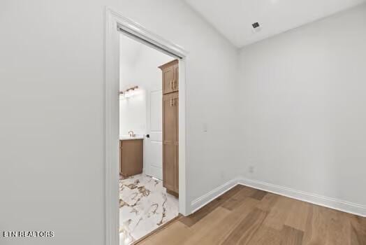 hall with hardwood / wood-style floors