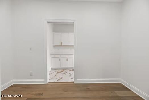 empty room with dark wood-type flooring