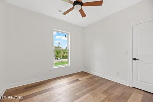 unfurnished room with light wood-type flooring and ceiling fan