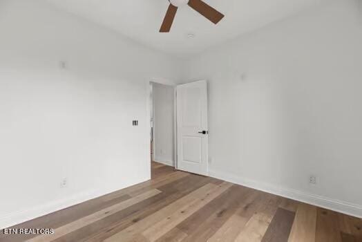 spare room featuring hardwood / wood-style floors and ceiling fan