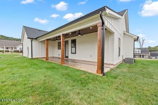 rear view of property featuring a lawn, ceiling fan, and a patio