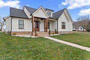 modern farmhouse with a front lawn