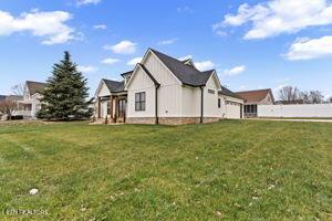 view of side of home featuring a lawn