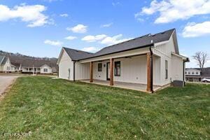 rear view of property featuring a yard