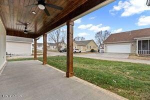 view of patio / terrace with ceiling fan and a garage