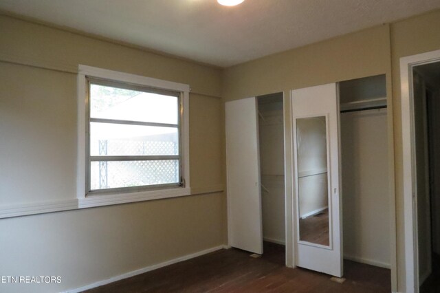 unfurnished bedroom featuring dark hardwood / wood-style flooring