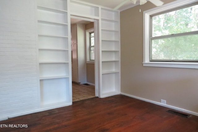 interior space with ceiling fan and dark wood-type flooring