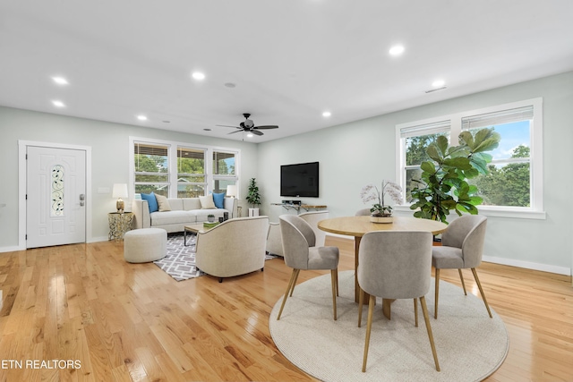 dining area with light hardwood / wood-style flooring and a wealth of natural light