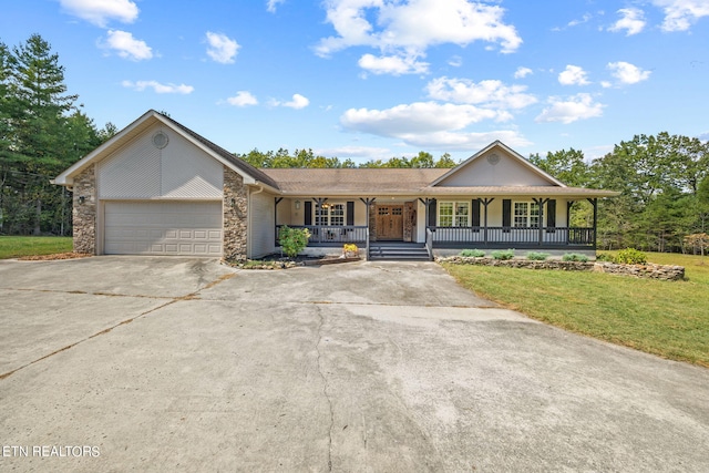 ranch-style home featuring a front yard, a garage, and covered porch