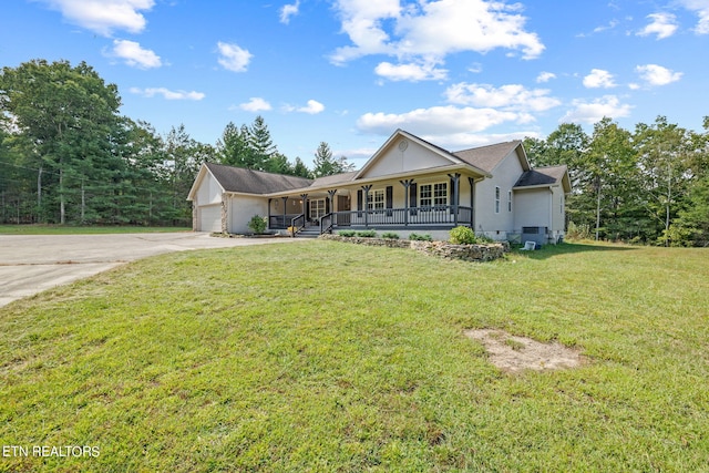 view of front of property with a garage, a front lawn, and covered porch