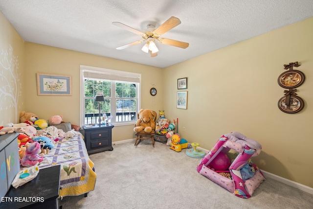 carpeted bedroom featuring a textured ceiling and ceiling fan