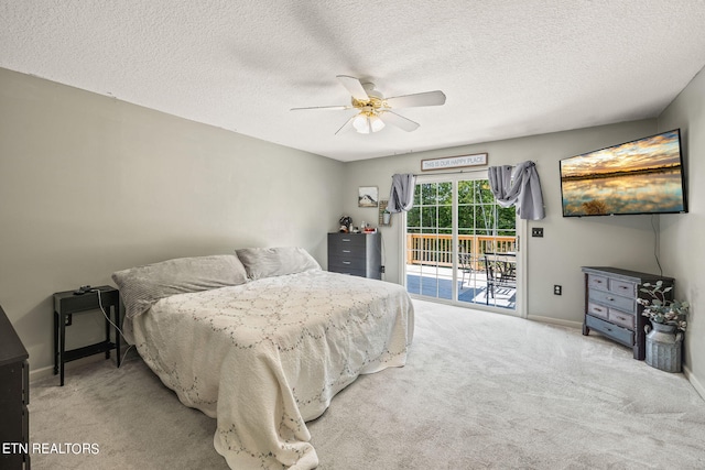 carpeted bedroom featuring ceiling fan, a textured ceiling, and access to outside