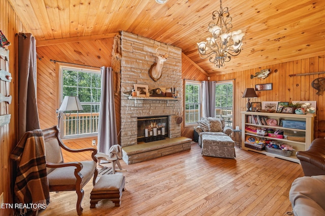 living room with light wood-type flooring, lofted ceiling, wooden ceiling, and a fireplace