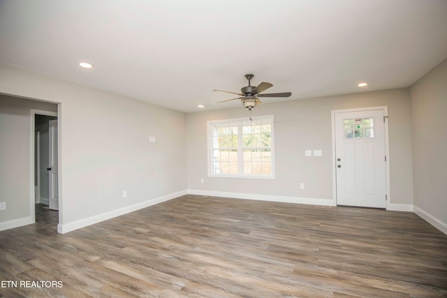 interior space with ceiling fan and dark hardwood / wood-style flooring