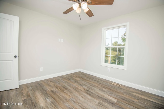 spare room featuring ceiling fan and dark hardwood / wood-style flooring