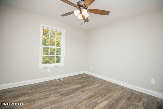 unfurnished room featuring ceiling fan and dark hardwood / wood-style flooring