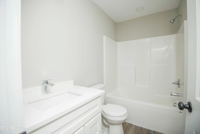 full bathroom with vanity, shower / bathtub combination, hardwood / wood-style floors, and toilet