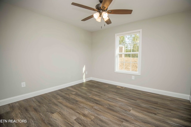 unfurnished room featuring dark hardwood / wood-style flooring and ceiling fan