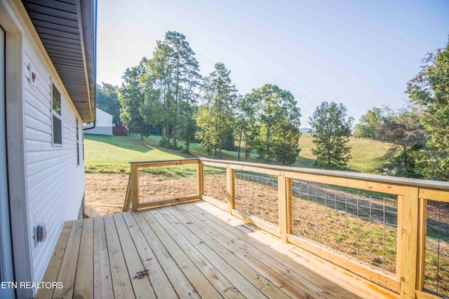 wooden deck with a lawn