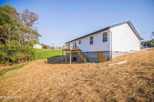 rear view of house featuring a deck and central air condition unit