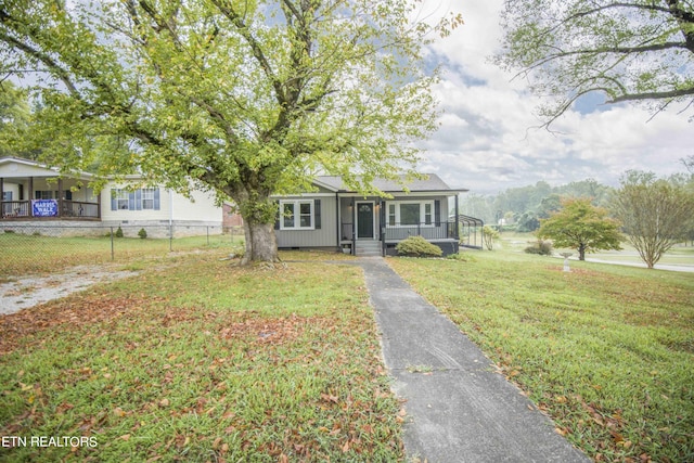view of front of house featuring fence, covered porch, crawl space, and a front yard