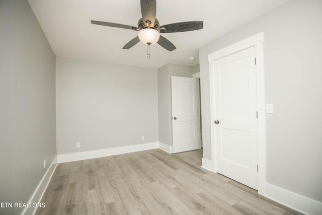 unfurnished room with ceiling fan, baseboards, and wood finished floors