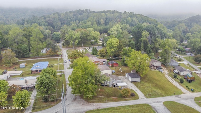 birds eye view of property featuring a residential view and a forest view