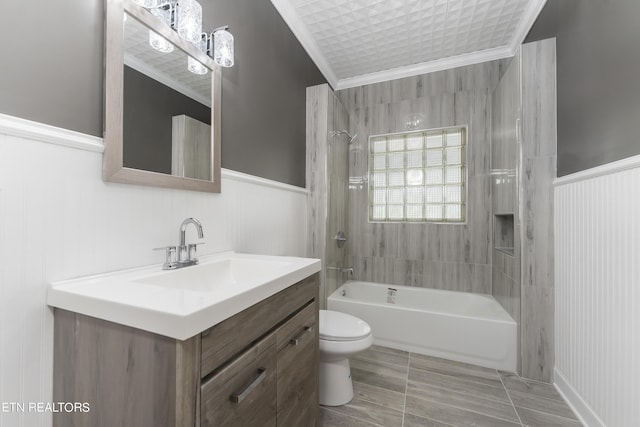 full bathroom with vanity, toilet, tiled shower / bath, and crown molding