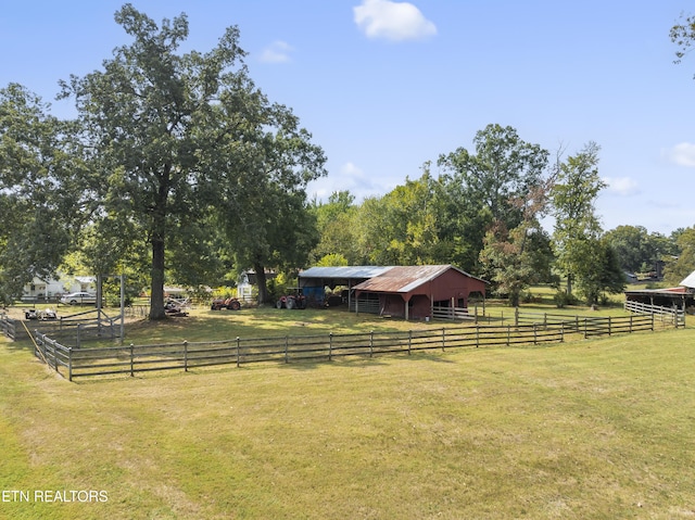 view of yard with a rural view and an outdoor structure