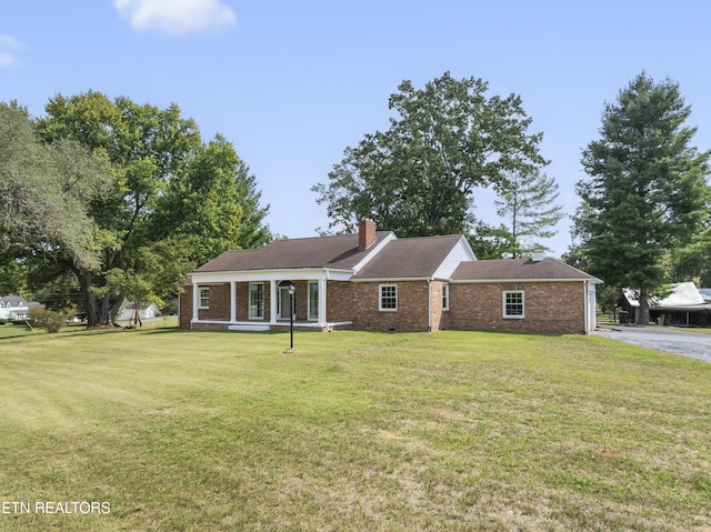 view of front of home with a porch and a front yard