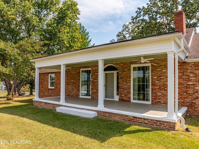 rear view of property with a porch and a yard