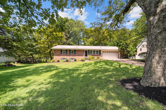 ranch-style house featuring a garage and a front lawn