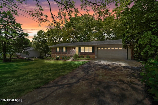 view of front of property with a lawn and a garage