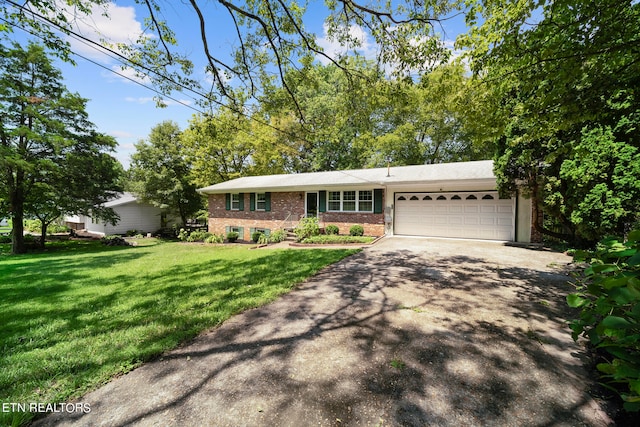 view of front of house featuring a garage and a front lawn