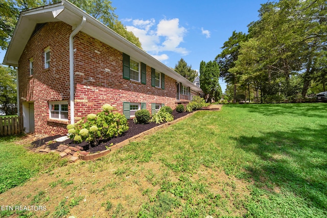 view of home's exterior with a yard