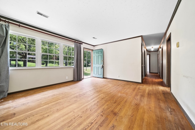 spare room featuring crown molding and hardwood / wood-style floors