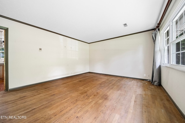 unfurnished room with crown molding and light hardwood / wood-style floors