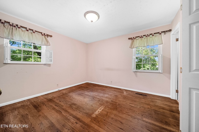 spare room featuring hardwood / wood-style flooring