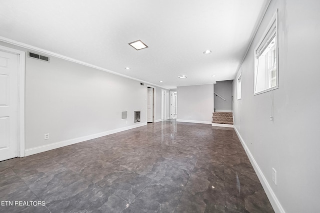 unfurnished living room featuring crown molding