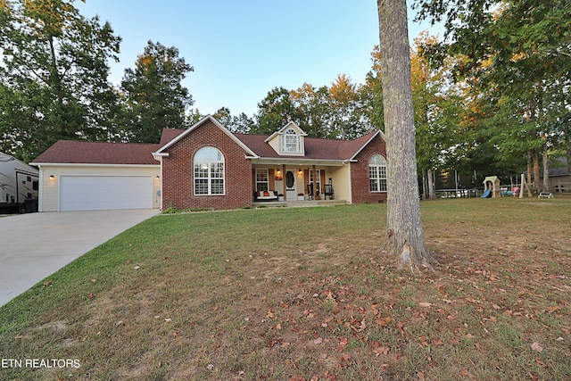 view of front of property with a front yard, a porch, and a garage