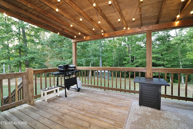 wooden terrace with a grill