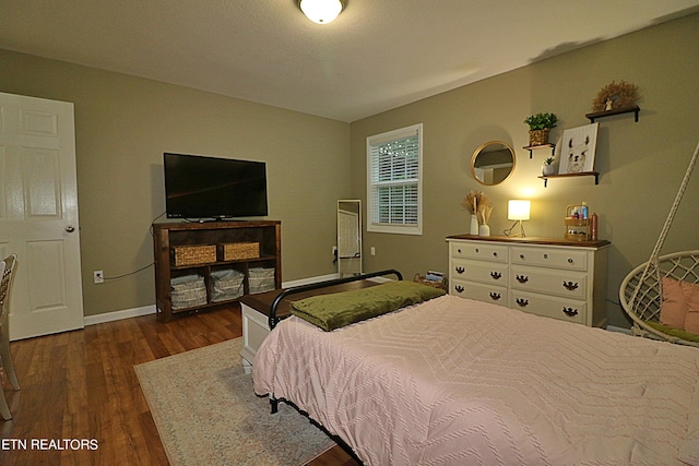 bedroom with dark wood-type flooring